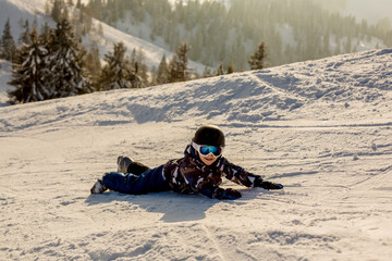 Fototapeta na wymiar Cute preschool child, boy, skiing happily in Austrian Apls