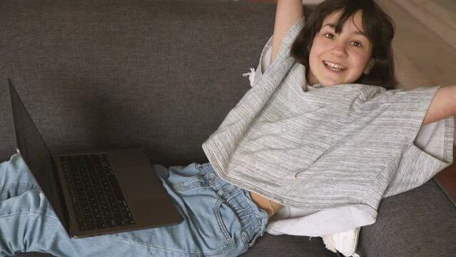 indoor portrait of pre-teen girl doing homework online or browsing internet, mdeia technologies, digital communication or shopping, teenager lifestyle. 