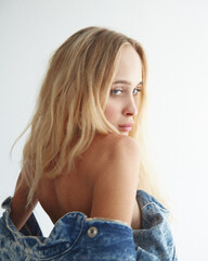 Long hair blonde model posing in studio on white background