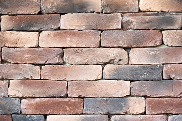 Brown brick wall texture. cement seams close-up, crumbling from old age. construction, repair