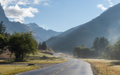 The road to Col de l'Iseran during morning fog, French Alps, Val-d'Isère, France