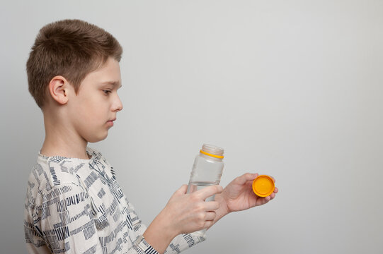boy uncorking a plastic bottle of water