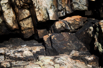 Abstract stone background. Old burnt stones. Grunge nature background. Selective focus.