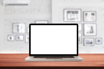 Fototapeta premium Laptop or notebook with blank screen on wood table in blurry background with coffee shop or modern office ,nature orange bokeh and sunlight in morning. vintage tone