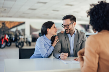 Happy caucasian couple in love, satisfied with their purchase.