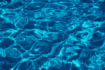 Clear water surface, rippled water in tiled swimming pool