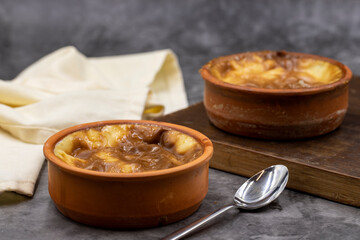 Casserole rice pudding on a dark background. A delicious dessert made with rice and milk. Traditional middle eastern cuisine delicacies. local name guvec sutlac