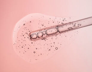 Liquid pink transparent gel or serum with dropper pipette on pink background - obrazy, fototapety, plakaty