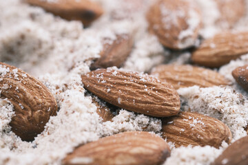 close up of almond and power in a bowl on table 