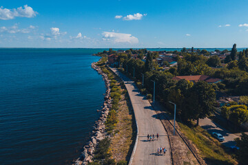Fototapeta na wymiar Kakhovskoye reservoir in the city of Nikopol. Ukraine. View from drone. Summer warm day. Place for a walk for adults and children near the water