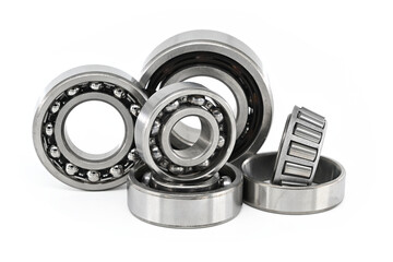 Group of various ball and roller bearings on white