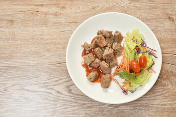 grilled slice beef ribeye steak dressing spicy barbecue sauce with salad on plate