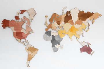 Wooden color map on the wall made of plywood. A world map without names and text.