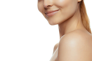 Naklejka premium Cropped image of tender female face, smile isolated over white studio background