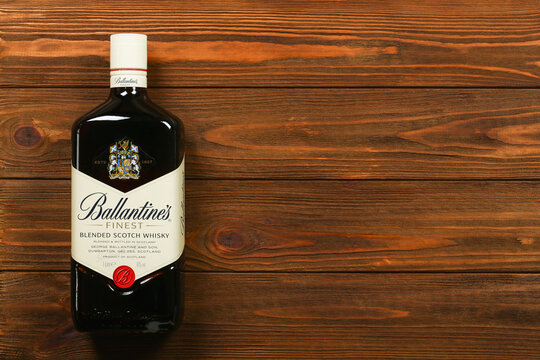 A bottle of Ballantines blended Scotch whisky on wooden background with copy space	