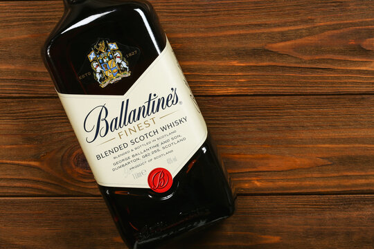 A bottle of Ballantines blended Scotch whisky on wooden background with copy space	