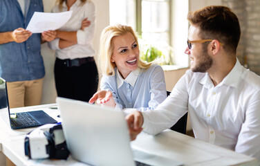 Portrait of business people having fun, working together and chatting at workplace office