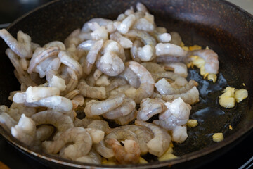delicious shrimp in a pan while they are being cooked. fresh food.