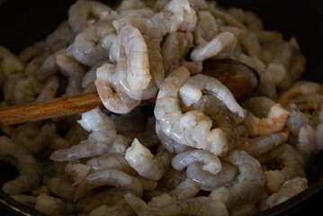 delicious shrimp in a pan while they are being cooked. seafood.