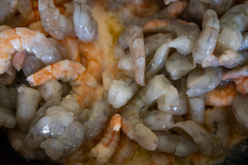 delicious shrimp in a pan while they are being cooked. seafood.