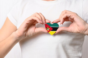 Flag of Mozambique in the shape of a heart in the hands of a girl. Love Mozambique. Respect for the...
