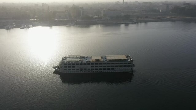 Aerial Drone shot of Boat in Nile River at Sunrise - Luxor, Egypt