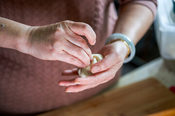 A chef is making buns in the Chinese kitchen