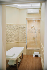 interior of the office of a doctor beautician - esthetician. Horizontal photo. Mock-up. office of a massage therapist, cosmetologist-esthetician with a shower cabin