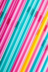 Multicolored blue yellow pink fuxia straws background retro 60's 50's 80's