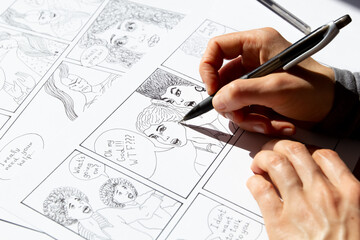 Storyboard of comic book characters drawn by the artist on paper sheets.