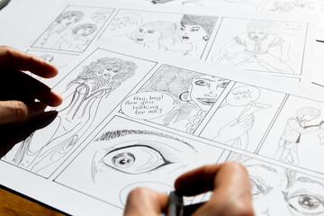 Storyboard of comic book characters drawn by the artist on paper sheets.