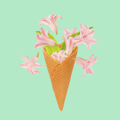 Art floral ice cream cone made of beautiful natural flowers. Trendy colorful blooming abstract idea...