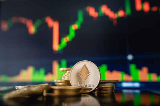 Stack or heap of silver Ethereum cryptocurrency with candle stick graph chart and digital background, on March 15, 2022, in Bucharest, Romania.