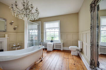 Victorian rectory bathroom with bath and chandelier