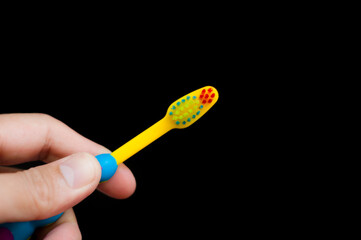 Colorfull toothbrushes for cleaning teeth baby when they wake up in the morning and a beautiful black background.