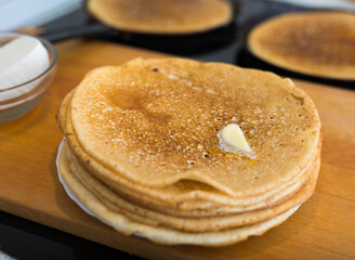 cooking traditional pancakes from wheat flour in the kitchen