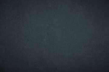 Dark gloomy blue and black slate background or texture with vignette