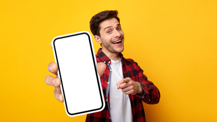Excited guy pointing at white empty smart phone screen
