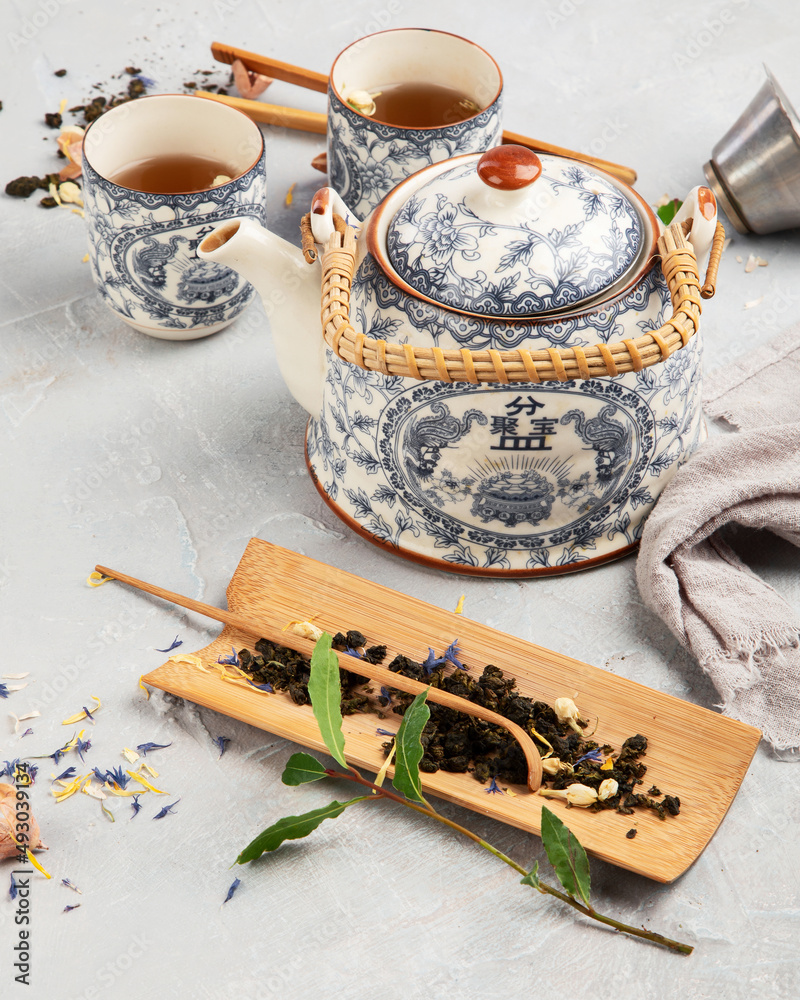 Canvas Prints asian teapot with herbal tea on light background.