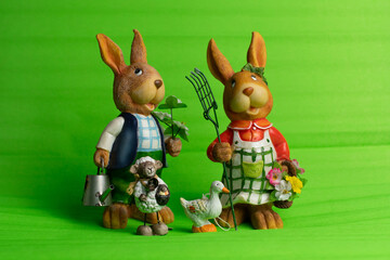 Group of ceramic figures, two rabbits with big bunny ears and gardening stuff, little sheep with...