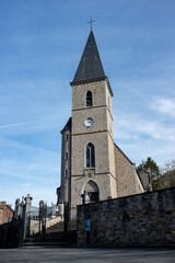 Fototapeta na wymiar Clock tower of a Gothic parish Belgian church.