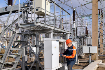 Electrical engineer inspecting switch cabinets in high voltage substations