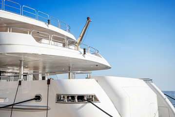 Part of a beautiful exquisite yacht against the sky.
