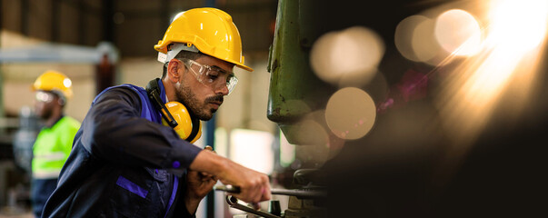 An expert male engineer or worker is working in an industrial plant. Workers work confidently.