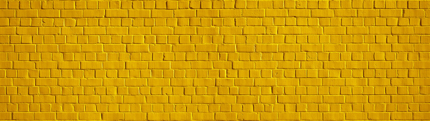 Yellow colored abstract rustic brick wall texture banner panorama