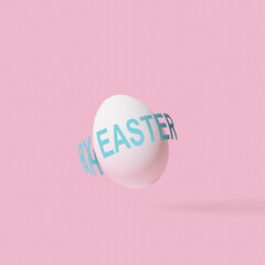 Happy easter text around egg on pink background. Creative typography design. Minimal abstract holiday idea.