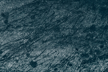 Stained dark blue concrete wall surface for texture background