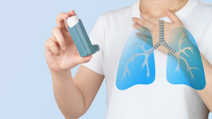 Young woman using blue asthma inhaler for relief asthma attack. Pharmaceutical products is used to prevent and treat wheezing and shortness of breath caused asthma or COPD. Lung organ anatomy. - obrazy, fototapety, plakaty