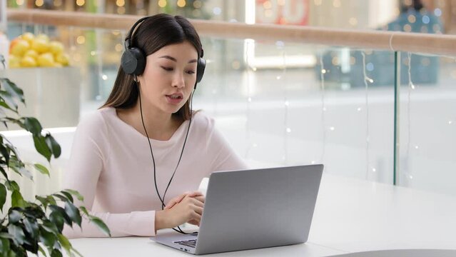 Asian woman worker manager female korean agent help line consultant girl in headset microphone at office cafe table e-learning online mentor business teacher studying talking support service operator