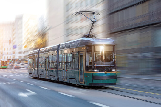 City tram rides through the streets of the city at a motion speed effect.